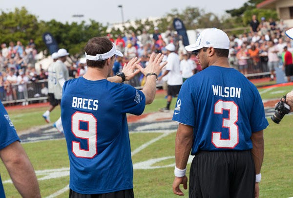 Drew Brees and Russell Wilson in a conversation during a match