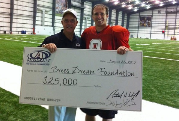 Drew Brees collecting a donation for his The Brees Dream Foundation