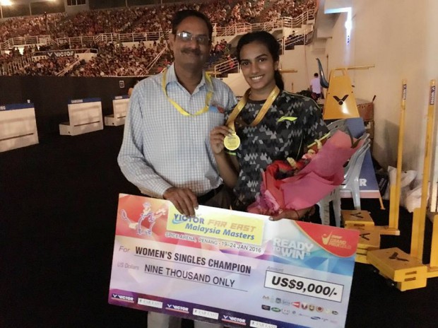 Sindhu with Malaysian Masters medal and prize along with her dad