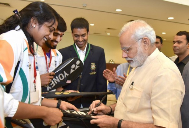 Indian prime minister Narendra Modi signing on Sindhu's Racquet